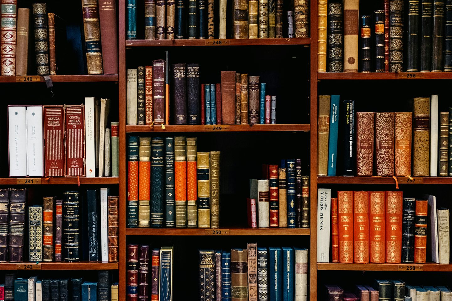 Rows of legal books arranged on polished wooden shelves.
